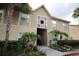 Inviting condo exterior with lush landscaping and tropical palm trees offering a serene and appealing entrance at 9916 Sweepstakes Ln # 1, Orlando, FL 32837