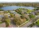 Aerial view of lakeside homes with a playground, surrounded by lush trees, in a serene neighborhood at 12018 Radbourne St, Winter Garden, FL 34787