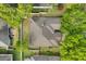 Aerial view of home with brown roof, surrounded by trees and white fence, in lush neighborhood at 12018 Radbourne St, Winter Garden, FL 34787