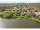 Aerial view of waterfront home with a private dock on a tranquil lake surrounded by lush greenery at 12018 Radbourne St, Winter Garden, FL 34787