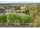 Aerial view of a charming home surrounded by lush trees and well-manicured lawns at 12018 Radbourne St, Winter Garden, FL 34787