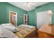 Comfortable bedroom features a patterned bedspread, a ceiling fan, and an ensuite bathroom at 12018 Radbourne St, Winter Garden, FL 34787