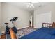 Bright bedroom features a ceiling fan, wood floors, and a comfortable exercise area at 12018 Radbourne St, Winter Garden, FL 34787