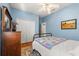 Bedroom featuring a blue color scheme, a ceiling fan, and traditional wooden furnishings at 12018 Radbourne St, Winter Garden, FL 34787