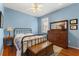 Comfortable bedroom with blue walls, a ceiling fan, and traditional furniture at 12018 Radbourne St, Winter Garden, FL 34787