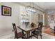 Dining room with wood table set, contemporary chandelier, and sliding glass door that leads to the backyard at 12018 Radbourne St, Winter Garden, FL 34787