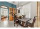 Formal dining room features a wooden table set, stylish light fixture, and large shuttered window at 12018 Radbourne St, Winter Garden, FL 34787