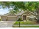 Charming single-story home with a well-maintained lawn, mature trees, and a neutral-tone exterior at 12018 Radbourne St, Winter Garden, FL 34787