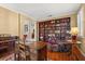 Comfortable living room with a full bookcase, hardwood floors, and a chair with footstool at 12018 Radbourne St, Winter Garden, FL 34787