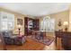 Cozy living room with hardwood floors, a plush chair, and a built-in bookcase at 12018 Radbourne St, Winter Garden, FL 34787