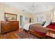Bright main bedroom features a large dresser, hardwood floors, and multiple windows at 12018 Radbourne St, Winter Garden, FL 34787
