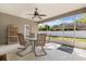Screened patio with ceiling fan and table with four chairs overlooking landscaped backyard at 12018 Radbourne St, Winter Garden, FL 34787
