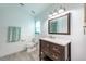 Well-lit bathroom with vanity, toilet, and an exhaust fan at 127 Thorne Meadow Pass, Davenport, FL 33897