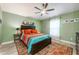 Charming bedroom featuring wooden ceiling fan and colorful decor at 127 Thorne Meadow Pass, Davenport, FL 33897