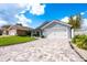 Well-maintained home exterior with a manicured lawn and a spacious driveway at 127 Thorne Meadow Pass, Davenport, FL 33897