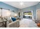 Comfortable living room featuring a large sectional sofa, sliding glass doors, and a modern ceiling fan at 127 Thorne Meadow Pass, Davenport, FL 33897