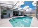 Screened-in pool with patio, grill, and outdoor seating, perfect for entertaining and enjoying the Florida weather at 127 Thorne Meadow Pass, Davenport, FL 33897