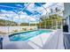 Inviting screened pool with a clear view and a white fence, perfect for a refreshing swim in privacy at 127 Thorne Meadow Pass, Davenport, FL 33897