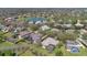 Aerial view of the residential neighborhood featuring beautiful homes and a serene lake at 12848 Jacob Grace Ct, Windermere, FL 34786