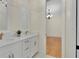 Double sink bathroom with marble countertops and a view into the next room at 12848 Jacob Grace Ct, Windermere, FL 34786
