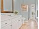 Bright bathroom featuring a white vanity, framed mirror, and a glass-enclosed shower at 12848 Jacob Grace Ct, Windermere, FL 34786