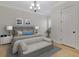 This staged bedroom includes a bench, lamps, and light colored walls at 12848 Jacob Grace Ct, Windermere, FL 34786