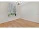 Sunlit bedroom showcases a window with shutters and beautiful hardwood floors at 12848 Jacob Grace Ct, Windermere, FL 34786