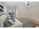 The bedroom features a view to the outside through plantation shutters and a grey color scheme at 12848 Jacob Grace Ct, Windermere, FL 34786