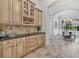 Elegant dining area featuring custom cabinets, granite counters, and a wine rack at 12848 Jacob Grace Ct, Windermere, FL 34786