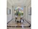 Bright dining room with elegant chandelier, large arched window, and beautiful tile flooring at 12848 Jacob Grace Ct, Windermere, FL 34786