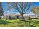 Beautifully landscaped front yard with mature trees shading a well-maintained single-story home at 12848 Jacob Grace Ct, Windermere, FL 34786