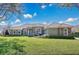 Charming single-story home featuring lush landscaping, a tile roof, and stone facade accents at 12848 Jacob Grace Ct, Windermere, FL 34786