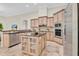 An open-concept kitchen featuring an island, stainless steel appliances, and custom cabinetry at 12848 Jacob Grace Ct, Windermere, FL 34786