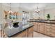 Spacious kitchen featuring a center island, granite countertops, and stainless steel appliances at 12848 Jacob Grace Ct, Windermere, FL 34786
