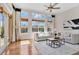 Bright living room with large windows, hardwood floors, and modern furniture at 12848 Jacob Grace Ct, Windermere, FL 34786
