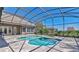 Screened-in pool and spa featuring beautiful brick pavers and a clear blue sky overhead at 12848 Jacob Grace Ct, Windermere, FL 34786