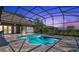Sparkling backyard pool and spa with screened enclosure and brick paver patio at 12848 Jacob Grace Ct, Windermere, FL 34786