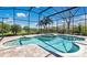 Beautiful in-ground pool with screened enclosure and lush landscaping at 12848 Jacob Grace Ct, Windermere, FL 34786