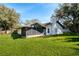 The backyard features a spacious green lawn with a sunroom and chimney at 1321 Medinah Ct, Winter Park, FL 32792