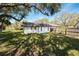 The home features a large fenced backyard with mature trees for shade and privacy at 1321 Medinah Ct, Winter Park, FL 32792