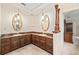 Bathroom featuring dual vanities and decorative wallpaper at 1321 Medinah Ct, Winter Park, FL 32792