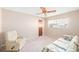 Cozy bedroom with a ceiling fan, window with blinds, and comfortable seating area at 1321 Medinah Ct, Winter Park, FL 32792