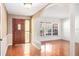 Inviting entryway featuring wood floors, decorative columns, and a glass accent front door at 1321 Medinah Ct, Winter Park, FL 32792