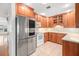 The kitchen features wood cabinets, white countertops, and stainless steel appliances at 1321 Medinah Ct, Winter Park, FL 32792
