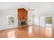 Bright living room with wood floors, a brick fireplace, and access to the back patio at 1321 Medinah Ct, Winter Park, FL 32792