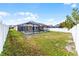 A spacious fenced-in backyard featuring a screened in pool at 13254 Boulder Woods Cir, Orlando, FL 32824