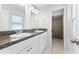Bathroom featuring double vanity with granite countertop and tiled shower at 13254 Boulder Woods Cir, Orlando, FL 32824