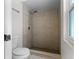 Bathroom featuring walk-in shower with tiled walls, shower head, and mosaic tile floor at 13254 Boulder Woods Cir, Orlando, FL 32824