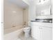 Classic bathroom featuring a tiled tub, single sink vanity, and neutral color scheme at 13254 Boulder Woods Cir, Orlando, FL 32824