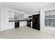 Functional kitchen featuring white cabinets, black appliances, granite countertops, and tile flooring at 13254 Boulder Woods Cir, Orlando, FL 32824